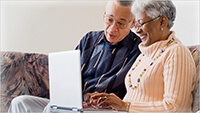 grandparents holding laptop